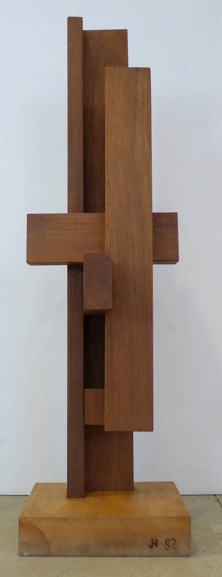 Tall constructivist sculpture of intersecting planes of wood by Dutch artist Johannes Hoog, dated 1982. A powerful and impressive work that references De Stijl architecture, tribal art, Brancusi, and Alexander Noll. A strong visual presence that can