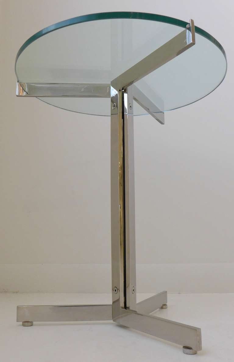 Tripod occasional table of chromed steel with glass top, by Swiss designer Hans Eichenberger.  Designed in 1956, this table was produced by Strassle in Switzerland c. 1960's for distribution in the U.S. market by Stendig.