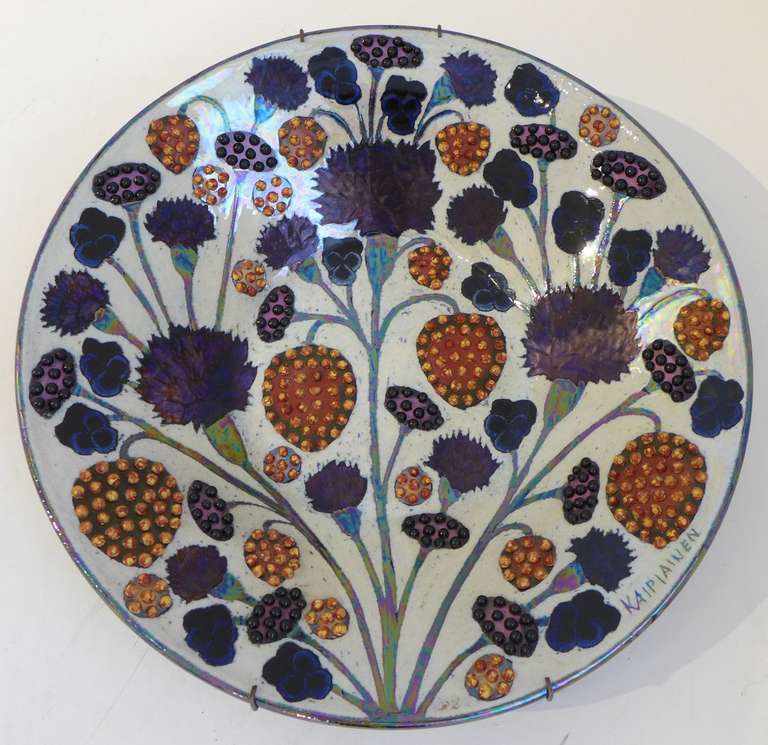 Large stoneware charger with multicolor floral decoration with iridescent glaze and ceramic pearls.  By Finnish ceramic artist Birger Kaipiainen (1915-1988), executed at the Arabia Factory, c. 1960.  A masterful example of Kaipiainen's work, with a