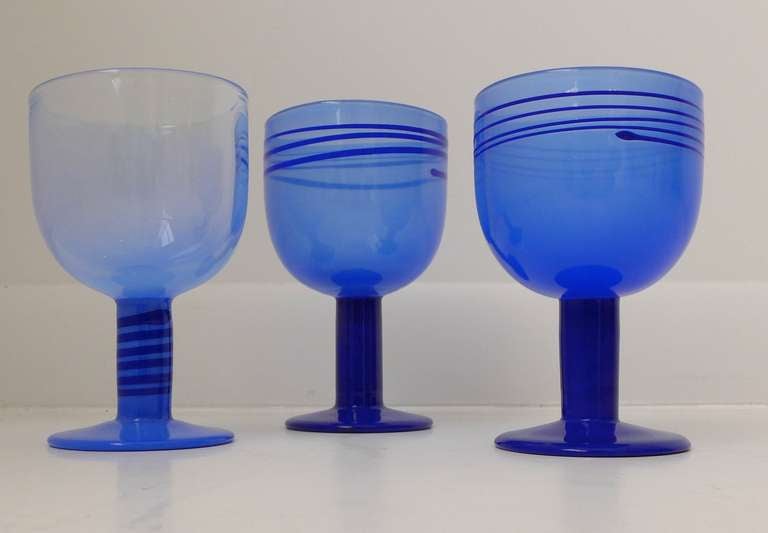 Three blue glass 'Pop' goblets by Swedish designer Gunnar Cyren, produced by Orrefors, c. 1968.  All with etched signatures.  PRICED INDIVIDUALLY. Measurement is of the tallest goblet.  NOTE:  GOBLET ON THE RIGHT IS SOLD.