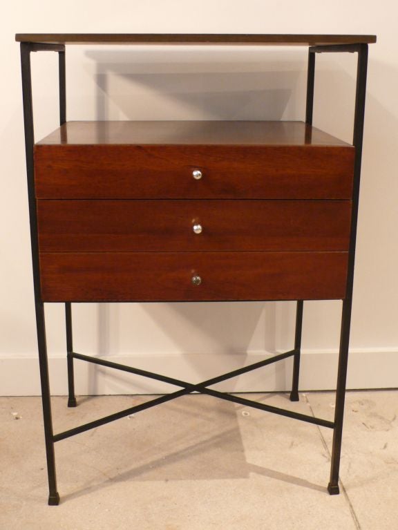 Cabinet designed by Arthur Umanoff with two drawers, top shelf, and metal cross stretchers, produced c. 1960's. Unusual configuration, suitable as a stand-alone cabinet or console.  Finished back. This line was distributed by Peter du Jardin/Tropic