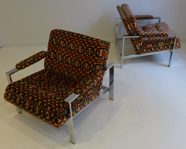 Pair of flat bar chrome lounge chairs designed by Milo Baughman and produced by Thayer Coggin, circa 1970s. Elegant, linear forms. The lack of a cross brace along the top rear gives a more open, sculptural look. The original fabric is still in fine