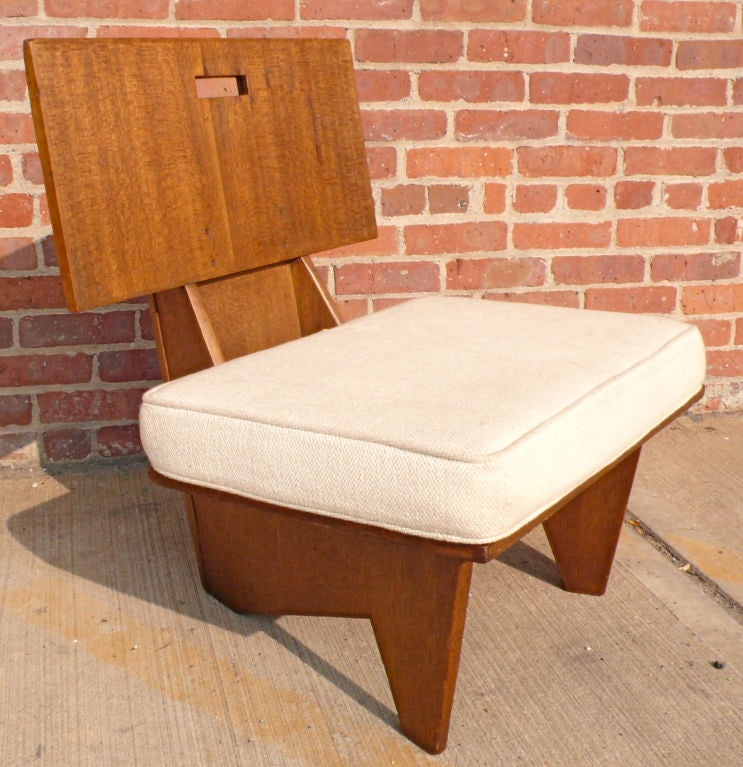 Lounge chair of mahogany and mahogany-veneered plywood made for the Dr. and Dorothy Turkel house in Detroit, MI, in 1955.  Terrific example of Wright's angular and organic forms of this period.  With detachable padded cushions.  The mate to this