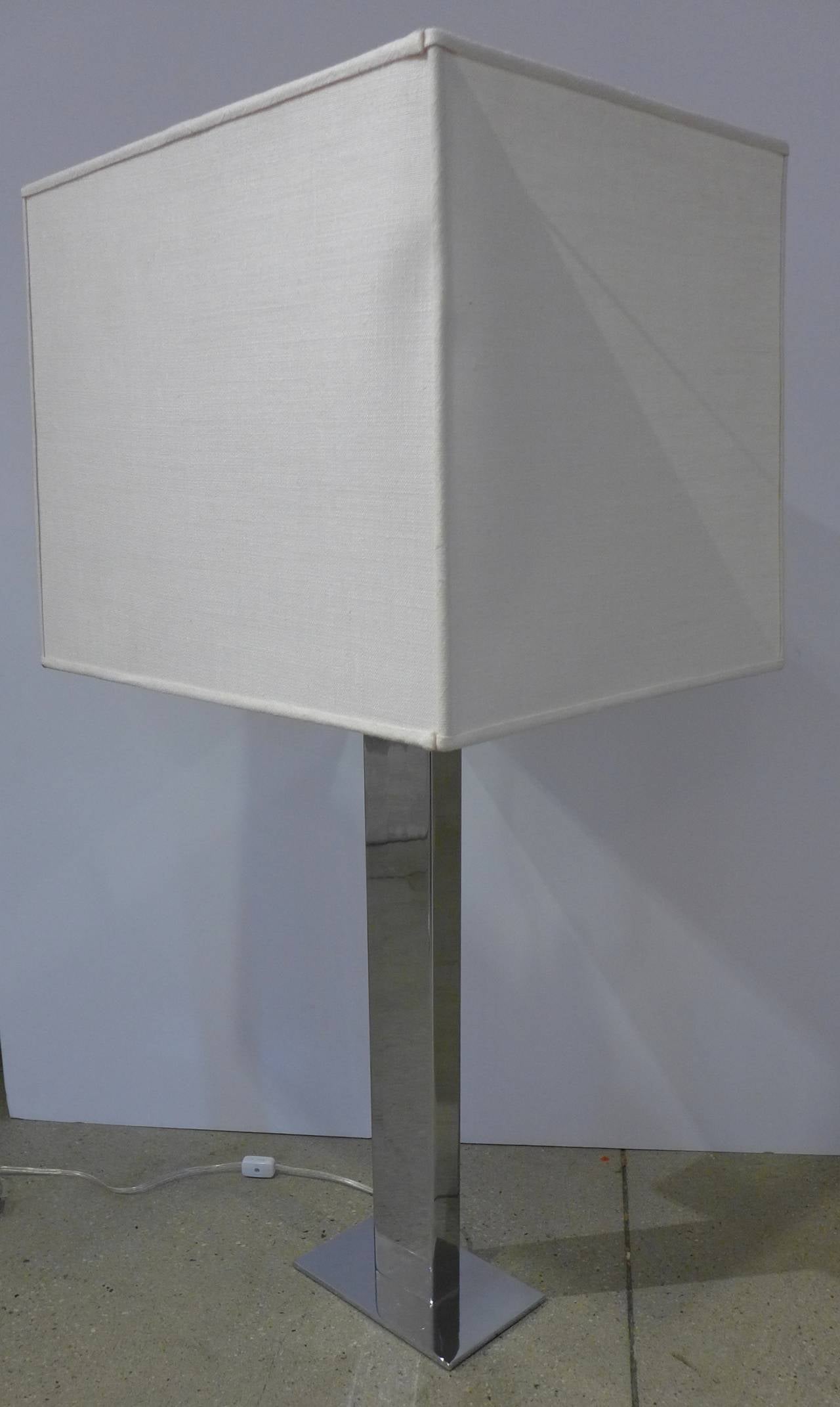 Columnar lamp of highly polished chromed steel, produced by George Kovacs, circa 1960s. With original shade. Newly wired. Measurements are of lamp alone. Shade measures 18.5