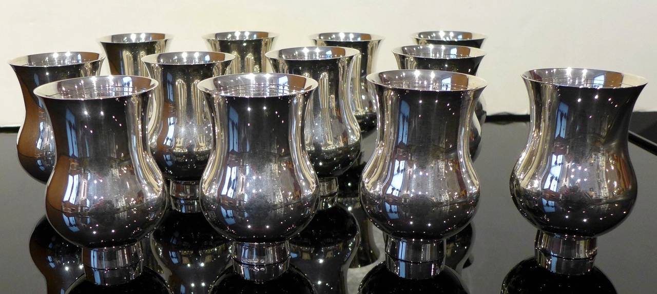 Set of twelve handmade sterling silver champagne beakers designed in 1999 as a collaboration between the champagne maker Bruno Paillarad and the silversmiths of Puiforcat. 10 ounce capacity. Ergonomically designed to enhance the champagne drinking