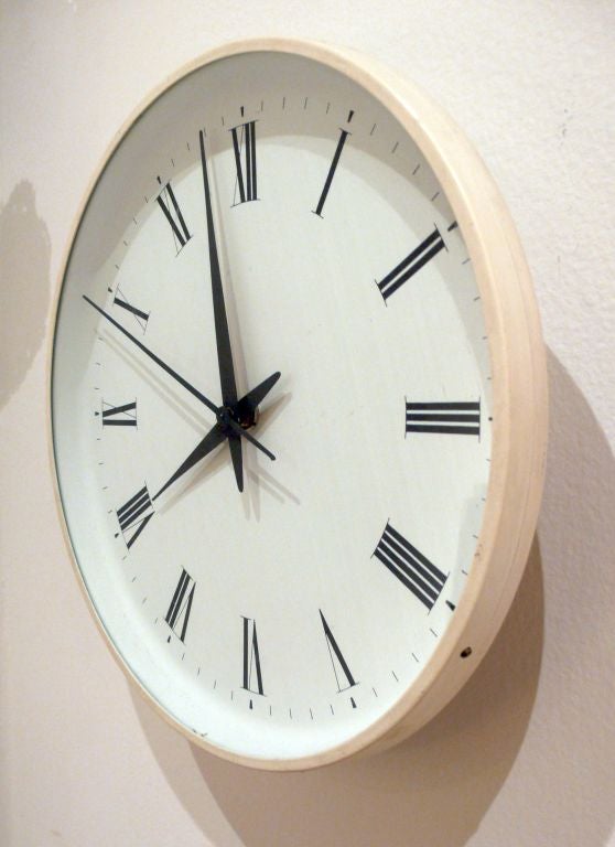 Electric wall clock with white lacquered metal frame designed by Henning Koppel c. 1963.  Produced by Louis Poulsen.