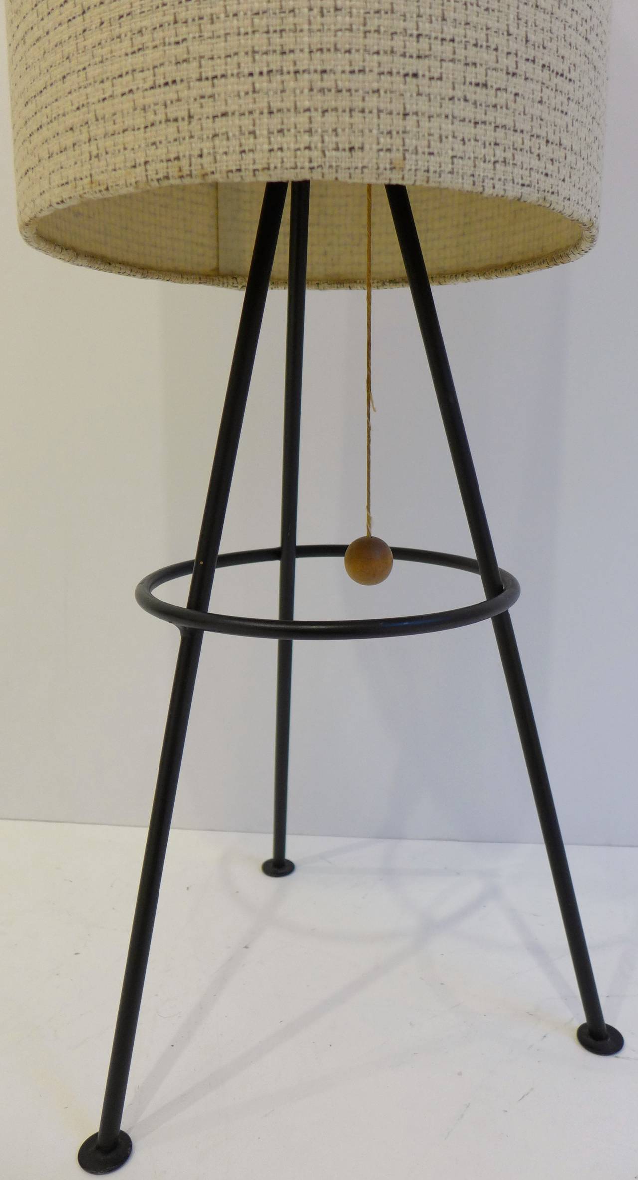 Rare table lamp of extruded metal with vintage woven shade and birch ball pull, produced c. 1952. Called a tripod lantern in the Lam Workshop catalog, it is a low-production design from an MIT-trained architect and designer who operated his own