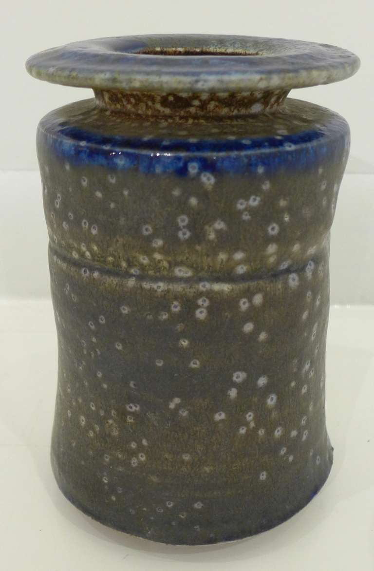 Double-rimmed vase of wood-fired, salt-glazed stoneware by renowned American potter Karen Karnes.  Characteristic indents and seams visible  in the body of the vessel; colors run the multi-chromatic glaze range from midnight blue to mossy brown and 