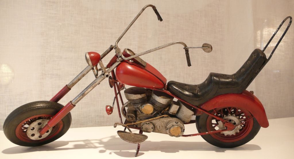 Vintage chopper model of painted metal and rubber. Nice patina and character.  Handlebars swivel, tires rotate.