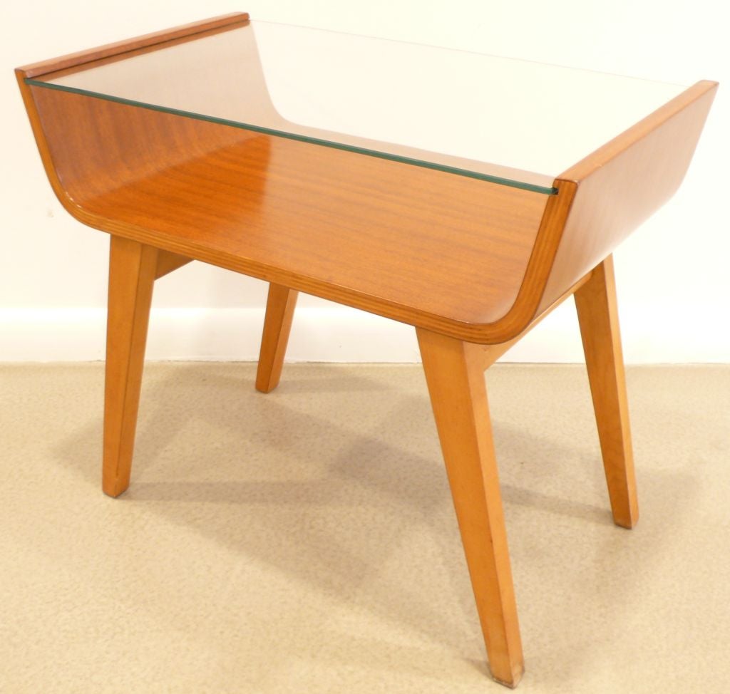 Rare U-shaped bent laminate side table with glass top designed by Allan Gould and produced by his Functional Furniture company, c. 1955.  Mahogany bent ply top with solid birch legs; two-tone laminate cross section.  Refinished, new glass.