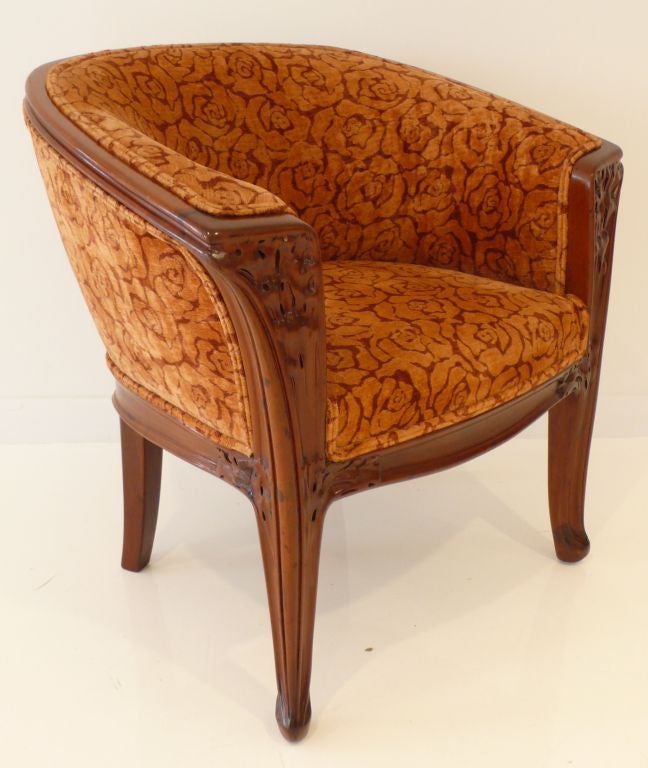 Curvy, elegant and gracious Art Nouveau armchair with vine carvings by Louis Majorelle, c. 1900.  Reupholstered in floral velvet. Comfortable and visually timeless.