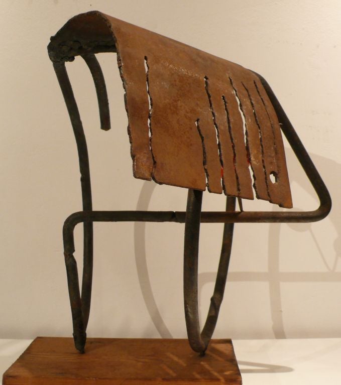 Abstract wrought iron sculpture with stylized coif that has a vision-in-motion quality of shifting between a profile or bust and what appears to be some type of hedgehog.  A playful, fanciful, and even humorous work that nevertheless exhibits a