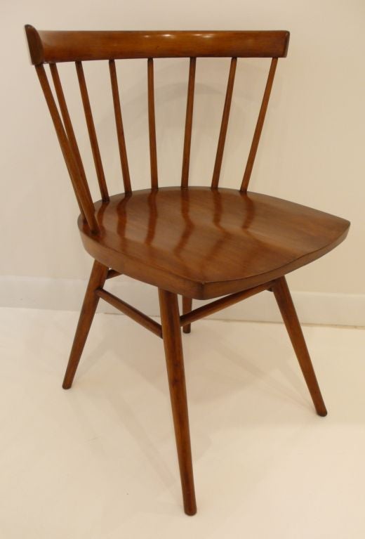 Curved-back chair designed by George Nakashima and produced for Knoll, c. 1948.  Shown in the 1948 and 1950 Knoll catalogs as item N19, this design preceded Nakashima's body of work at New Hope. Steamed, bent, carved, and turned walnut.  One chair