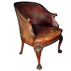 A Georgian Carved and Leather Upholstered Barrel Back Armchair