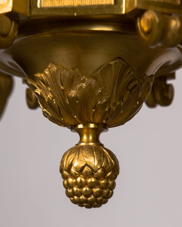 Neoclassical Six Arm Gilded Bronze Chandelier with Ram's Heads and Foliate Details, ca 1910s For Sale