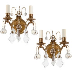 A pair of double light gilded bronze and crystal sconces