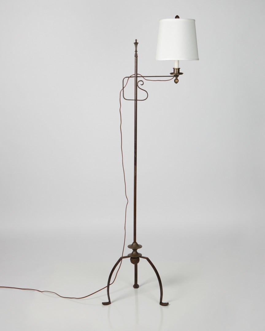 An Adjustable Height Wrought Iron Floor Lamp