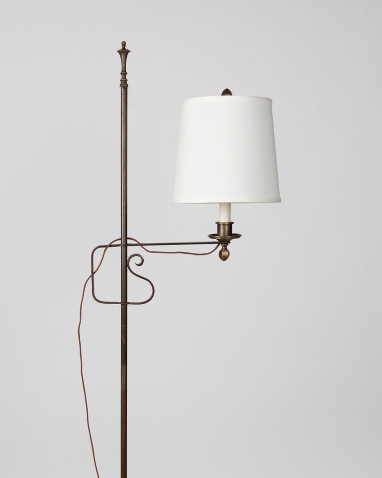 AFL1825

An antique wrought iron floor lamp with an adjustable height bridge arm on a slender column and a tripod base. Shade not included.

Overall (extended): 73-1/4