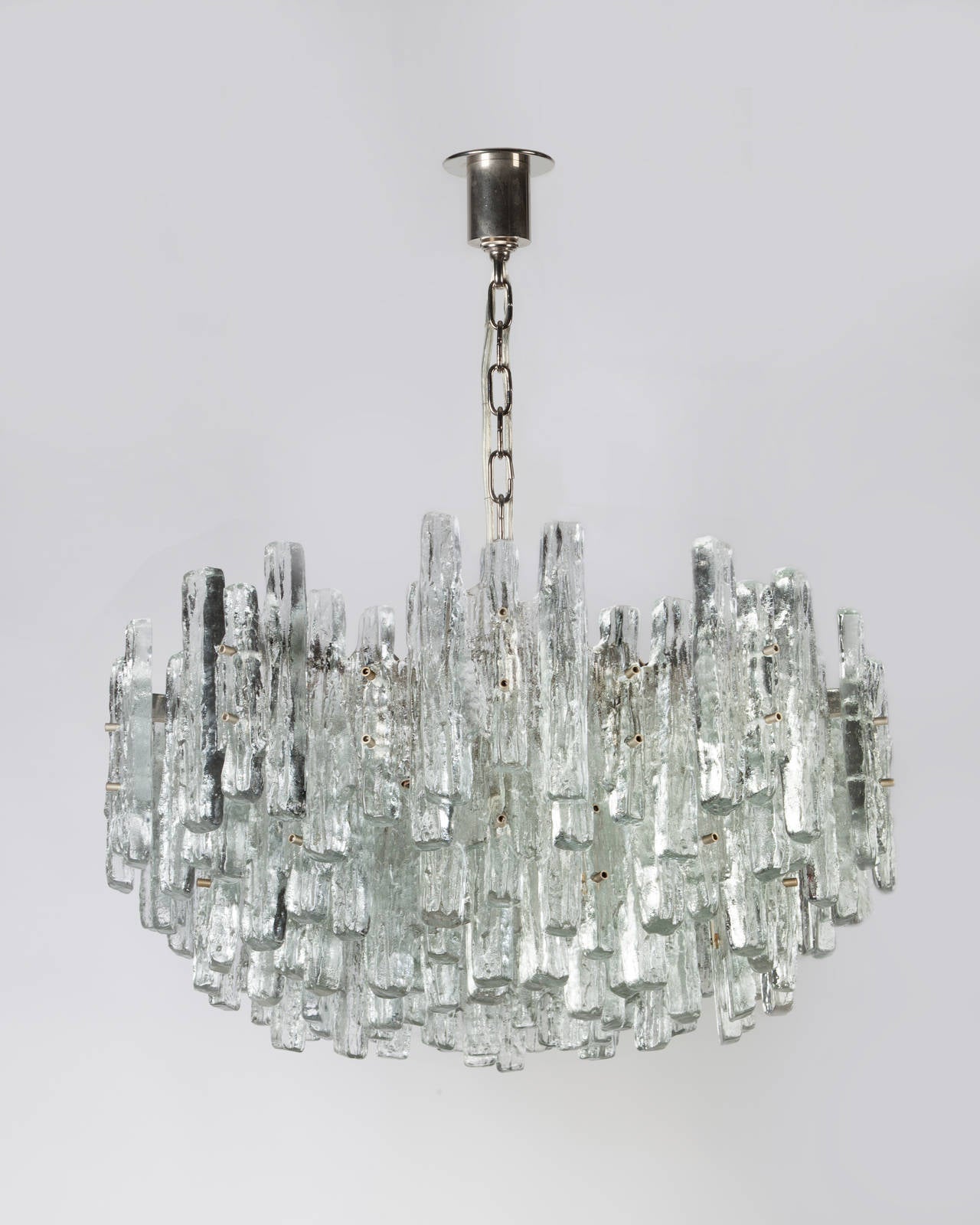 AHL3868

Circa 1970
A large thirty-light vintage chandelier with a nickel frame dressed with textured cast glass ice style prisms. By the Austrian maker Kalmar. Due to the antique nature of this fixture, there may be some nicks or imperfections