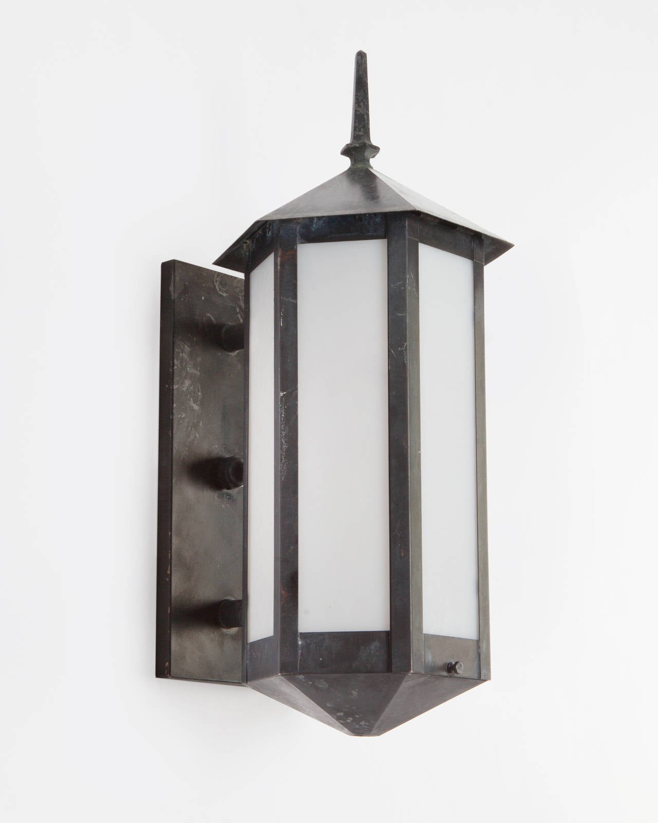 AEX0580
A pair of antique hexagonal wall lanterns in their original aged blackened brass finish. Glazed with pebbled opaline glass panels. Due to the antique nature of this fixture, there may be some nicks or imperfections in the