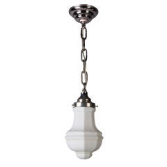 An octagonal white glass and nickel pendant