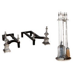 An antique set of silver andirons and firetools