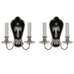 An Antique pair of silver mirror back sconces