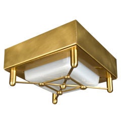 A solid brass and cast glass modern flushmount