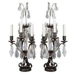 A pair of bronze Caldwell candelabra