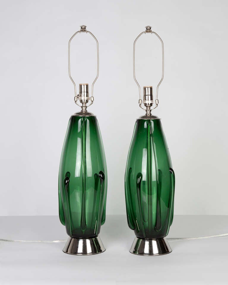 Circa 1950.  A pair of hand-blown green glass lamps with polished nickel fittings. Due to the antique nature of this fixture, there may be some nicks or imperfections in the glass.

DIMENSIONS
Overall: 28-3/4