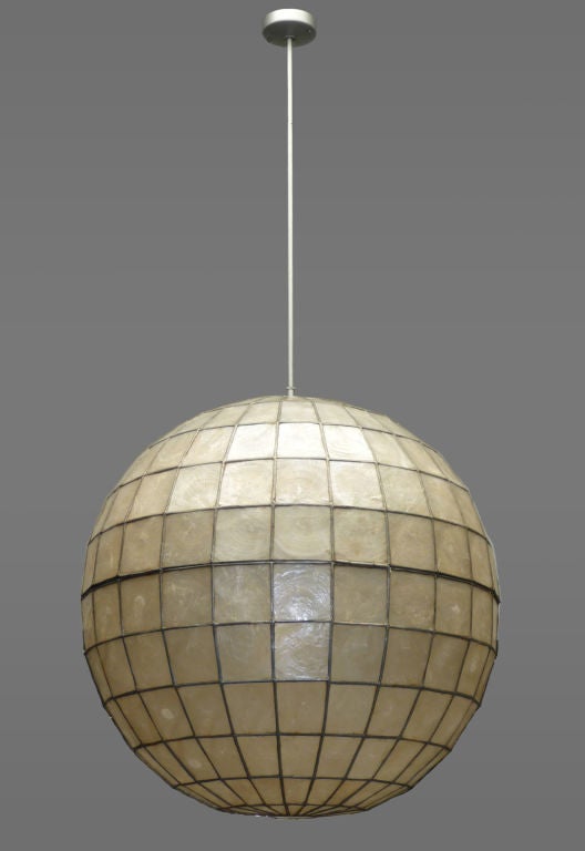 HL3609<br />
A large spherical lantern made of fine capiz shell tiles held in a copper foil and leadwork frame suspended from brushed chrome fittings. From a Pacific Palisades home remodeled by Los Angeles architect Raymond Kappe whose drawing