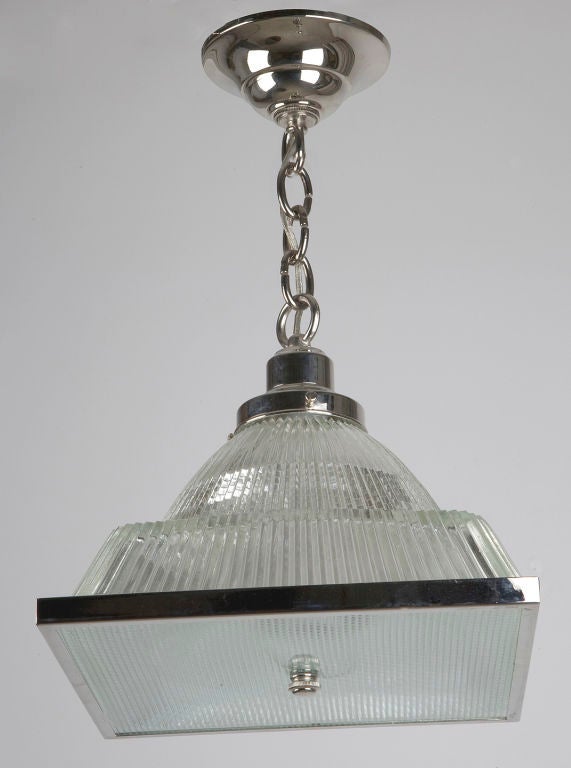 AHL3611

A rounded, semi-pyramidal holophane glass pendant with square diffuser on polished nickel fittings made in the Remains Lighting Co. workshop. Due to the antique nature of this fixture, there may be some nicks or imperfections in the glass