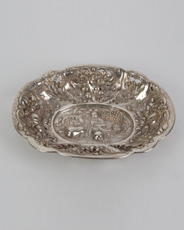 ATA1391

A sterling silver open-work dish with crisply chased fruit and foliate details. Signed by the maker E. F. Caldwell. The underside of the tray has a plate with an engraved inscription.

Overall: 1-3/4