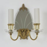 A single mirrored bronze sconce