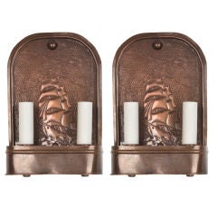 A pair of copper repousee sconces