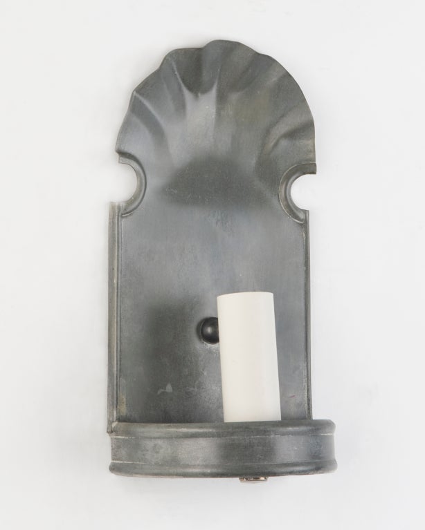 A pair of traditional scallop-topped pewter sconces at 1stdibs