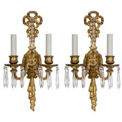 A pair of gilded bronze two-arm sconces