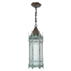 A hexagonal verdigris lantern with snowflake glass