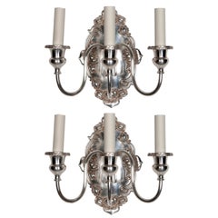 A pair of three-arm sconces by Sterling Bronze Co.