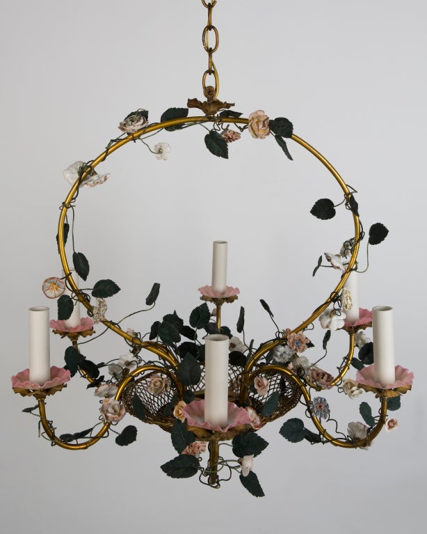 A six-light brass and ceramic floral chandelier