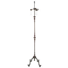 A bronze and iron floor lamp