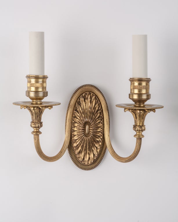 AIS2775

A pair of Baroque style double light bronze sconces in their original age-darkened finish, detailed with foliate low relief between plain, raised borders.

Overall: 11