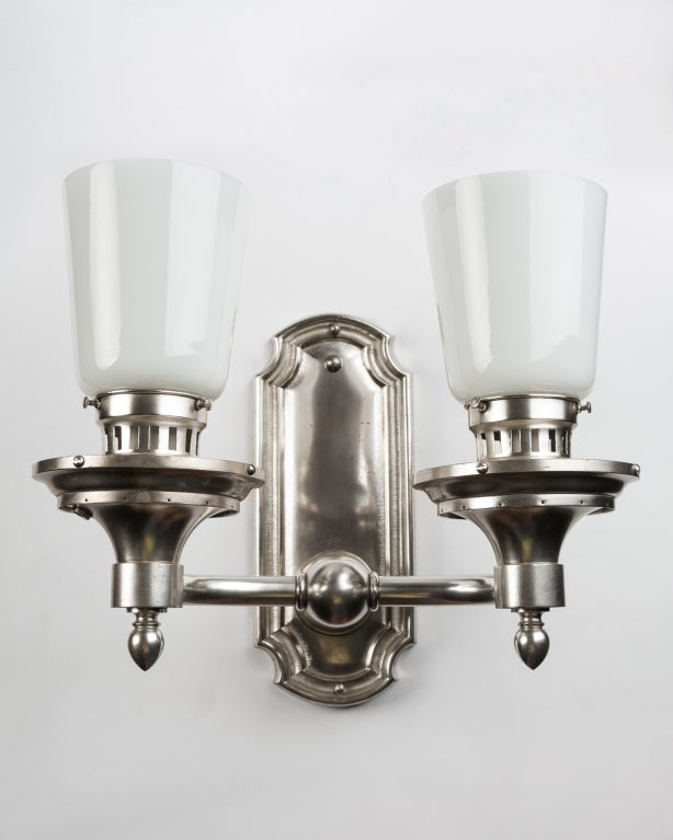 AIS2779
A pair of double light sconces with muscular proportions in their original silverplate finish. Having opal glass shades.

Dimensions:
Overall: 11-1/2
