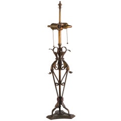 A Wrought And Cast Iron Table Lamp