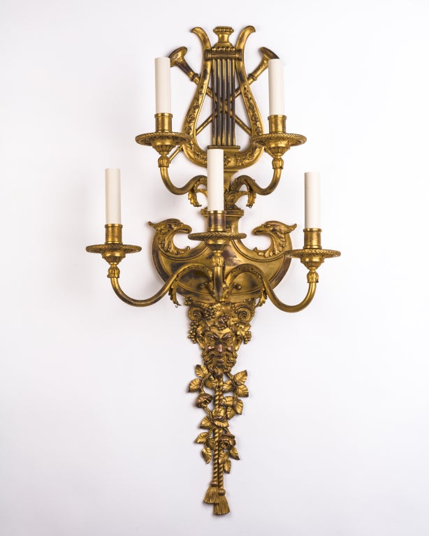 AIS2807

A pair of five light neoclassical sconces having backplates detailed with lyres and Bacchus masks. All the details are remarkably crisp. The finish is a beautiful worn gilding. Attributed to the New York maker E. F. Caldwell