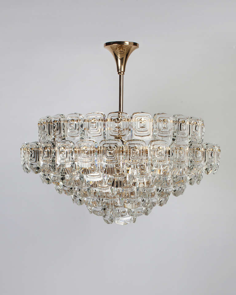 AHL3817

Circa 1960
A seven-tier chandelier with cascading textured glass pieces on a gilded frame. Attributed to the Austrian maker Kinkeldey. Due to the antique nature of this fixture, there may be some nicks or imperfections in the glass as