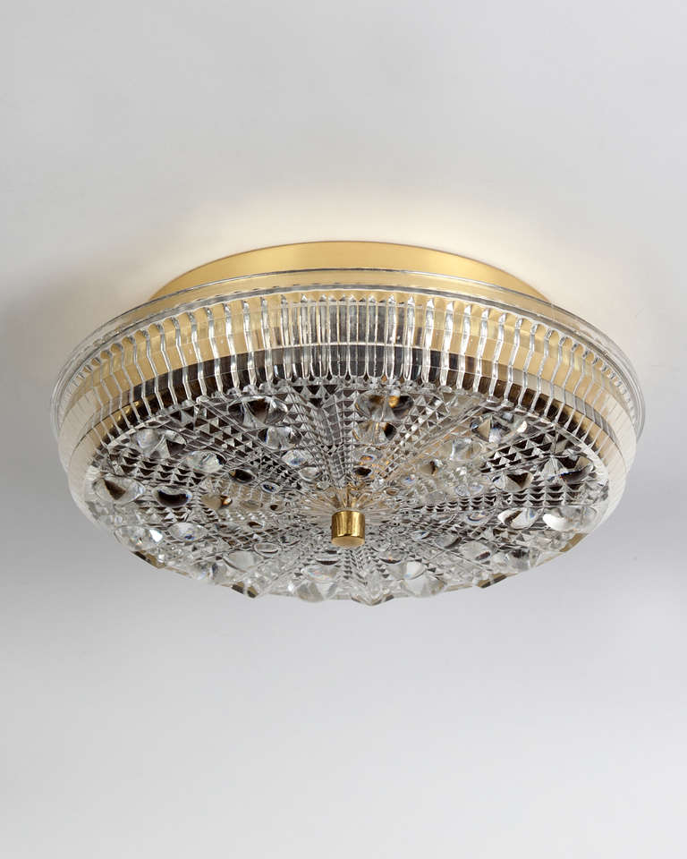 AHL3824

Circa 1950
A textured glass flush mount with brass fittings. Signed by Carl Fagerlund for the Swedish glassmaker Orrefors. Due to the antique nature of this fixture, there may be some nicks or imperfections in the glass as well as