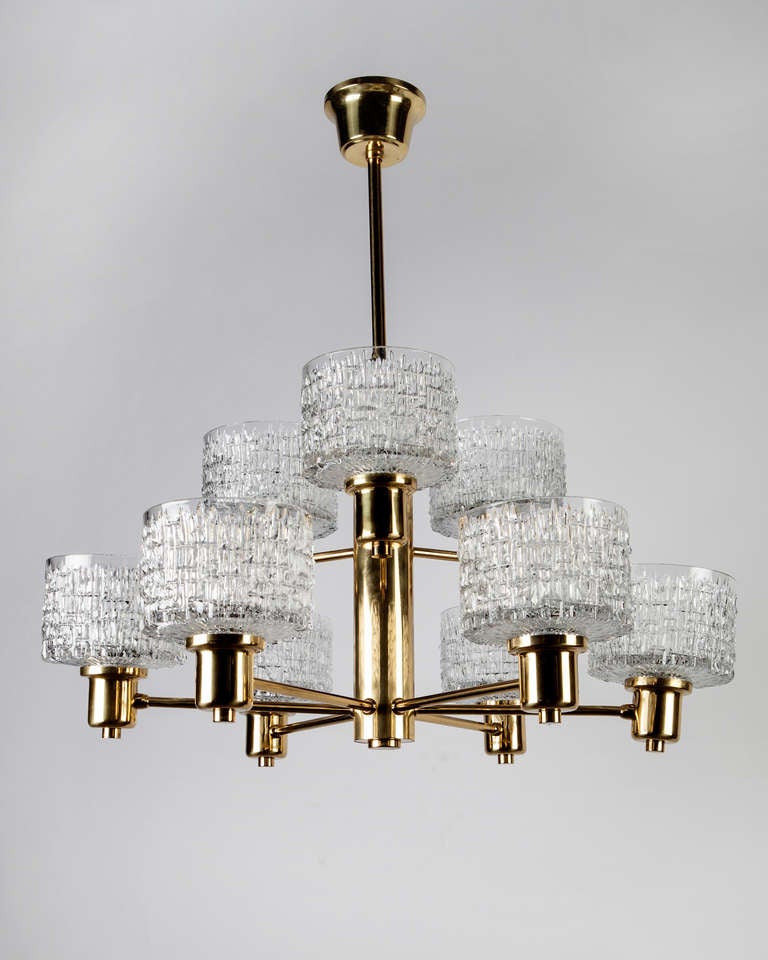 AHL3825

Circa 1960
A nine-light chandelier in its original brass finish with textured glass shades designed by Hans-Agne Jakobsson. Due to the antique nature of this fixture, there may be some nicks or imperfections in the glass as well as