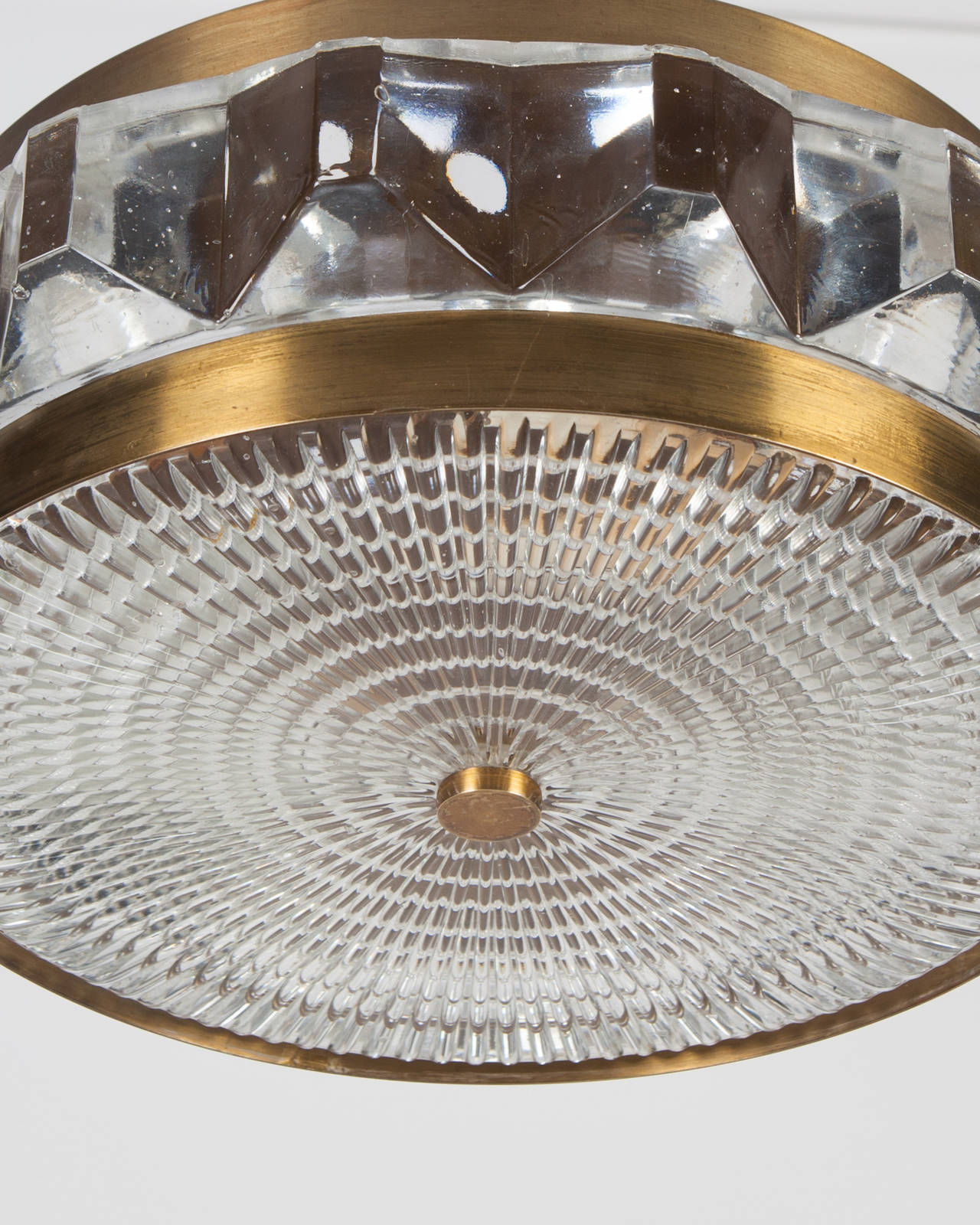 AHL3922

Circa 1960
A cut glass pendant in its original aged brass finish. Attributed to the Swedish glassmaker Orrefors. Due to the antique nature of this fixture, there may be some nicks or imperfections in the glass as well as variations from