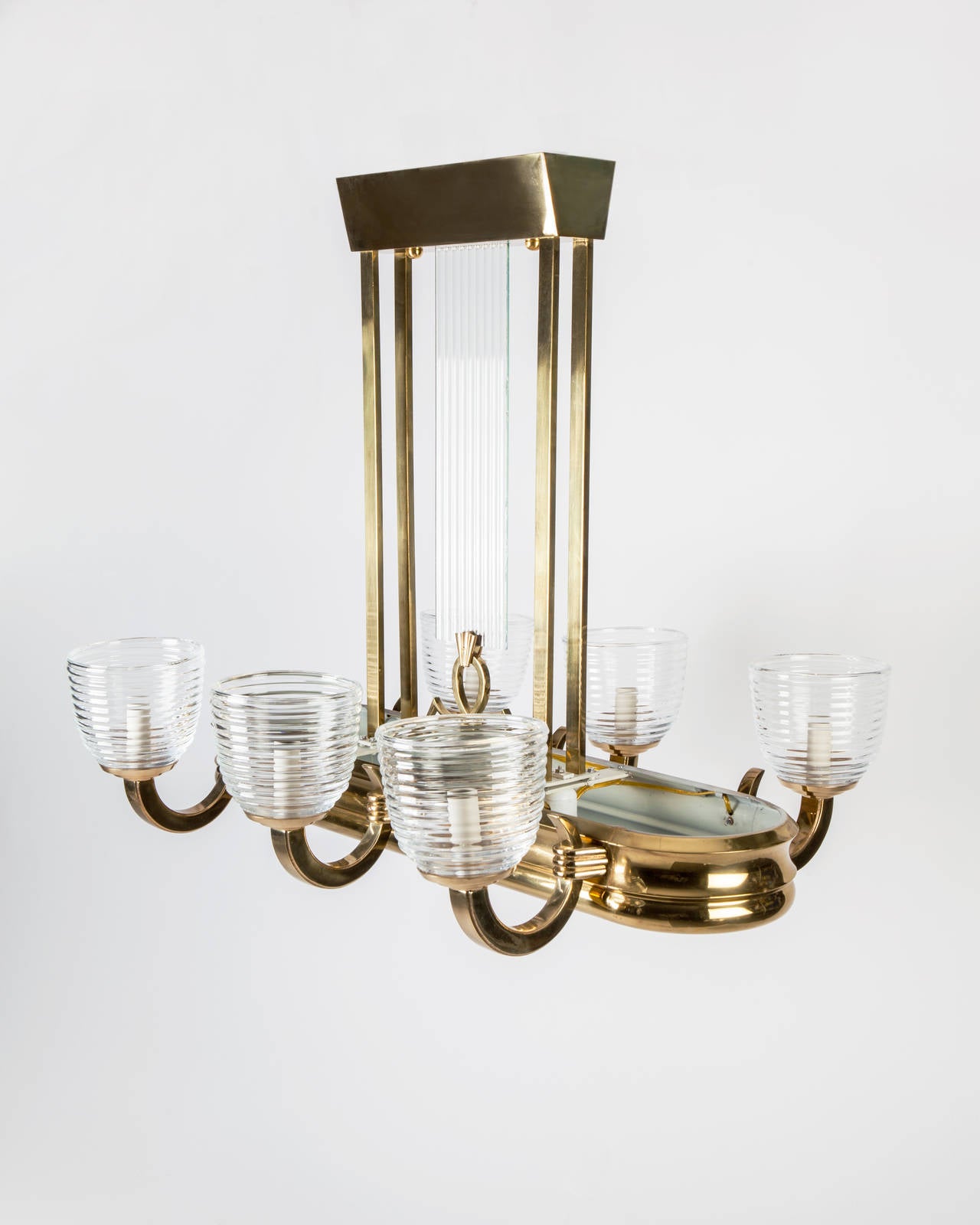 AHL3924
An antique Art Deco period chandelier with blown ribbed glass shades in an aged polished and lacquered brass finish. Due to the antique nature of this fixture, there may be some nicks or imperfections in the glass. Circa